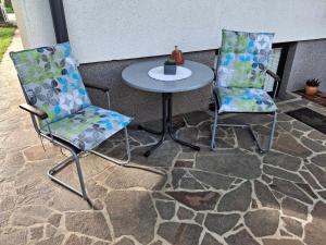 two chairs and a table on a patio at Prenočišče Breza in Radovljica