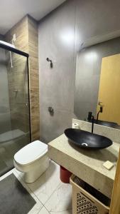a bathroom with a sink and a toilet and a shower at Izze Home in Palmas