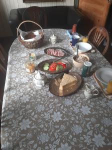 a table with plates of food on top of it at Strandhgarden B&B Cozy Room near Malmo in Oxie