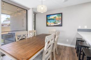 a dining room with a wooden table and chairs at 103 Kihei Holiday in Kihei +17 photos