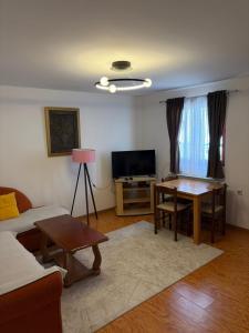 a living room with a table and a couch at Apartments Grbović in Žabljak