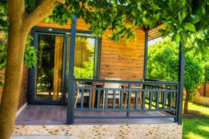 a screened porch with a table and chairs on a house at Çıralı Villa 2 in Kemer