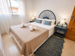 a bedroom with a large bed with towels on it at Dream house with Sea Views in La Mata Beach in Torrevieja +28 photos