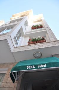 a blue umbrella sitting on top of a white building at Deka Evleri in İzmir