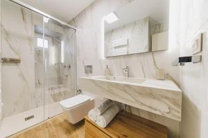 a white bathroom with a sink and a toilet at Best view Giovinazzo in Giovinazzo +35 photos