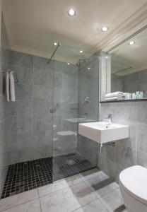 a bathroom with a shower and a sink and a mirror at Albany House in Dublin +35 photos