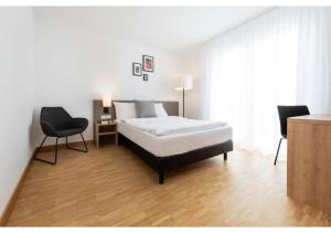a bedroom with a bed and a table and chairs at Brera Stuttgart in Stuttgart