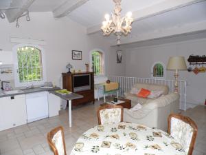 a kitchen and living room with a table and a couch at le Mas du Pin Vert in Aubagne