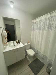 a bathroom with a toilet and a sink and a mirror at Exponor 2026 DEPARTAMENTO 1 DORMITORIO in Antofagasta