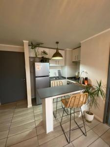 a kitchen with a table and chairs in a room at Exponor 2026 DEPARTAMENTO 1 DORMITORIO in Antofagasta +2 photos