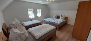 a room with three beds with pillows on them at Hirschhäusl in Großschönau