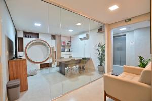 a living room with a table and a mirror at Premium Office-My Stay 02 in Brasília