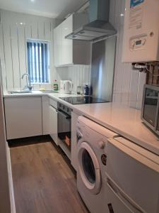 a kitchen with a washing machine and a sink at Waterloo apartment in Middlesbrough