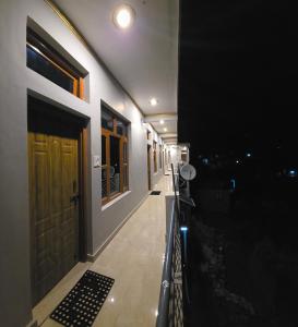 a hallway of a house at night with a door at Shree Rameshwaram Retreat in Gupta Kāshi