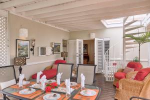a living room with a table and chairs at 3BR Beachfront Villa w/ Staff-DRMNV in Duncans