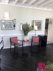 a living room with two chairs and a table at 3BR Beachfront Villa w/ Staff-DRMNV in Duncans