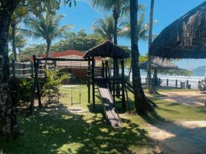 a playground on the beach with palm trees at Condo-Resort Juquehy, 4 quartos, em frente ao mar in São Sebastião
