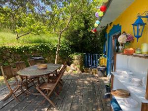 a patio with a table and chairs on a deck at Casa S. Nicolau in Cabeceiras de Basto