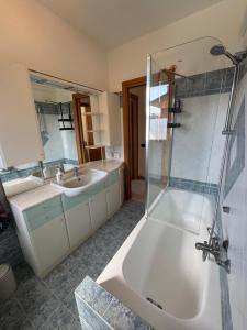 a bathroom with a tub and a sink and a shower at Casa Serena - Sarnico in Sarnico +19 photos