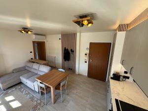 a living room with a couch and a table at Casa Serena - Sarnico in Sarnico