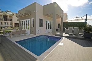 a house with a swimming pool in the yard at 3BR Modern Villa w/ Private Pool & Fire Pit in Saint Philip
