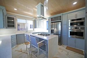 a kitchen with a island with a stove at 3BR Modern Villa w/ Private Pool & Fire Pit in Saint Philip