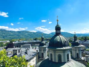 a building with a cross on the top of it at La Maison in Salzburg