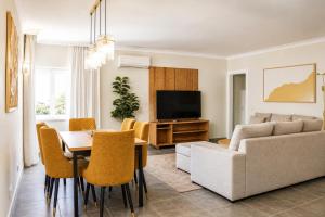 a living room with a couch and a table at Santa Eulalia Hotel & Spa in Albufeira