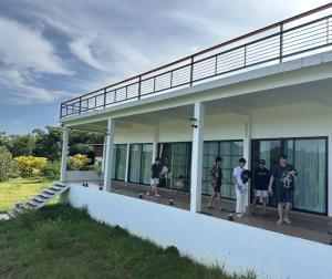 a group of people standing outside of a building at Boonfarm&homestay in Ban Nop Hak
