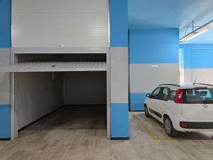 a white car parked in a parking garage at TERRA HOME Gaeta - Moderno Bilocale nel Borgo in Gaeta