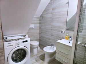a bathroom with a washing machine and a sink at TERRA HOME Gaeta - Moderno Bilocale nel Borgo in Gaeta +9 photos