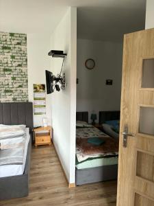 a bedroom with a bed and a sliding door at Pokoje U Anny i Łukasza in Swornegacie