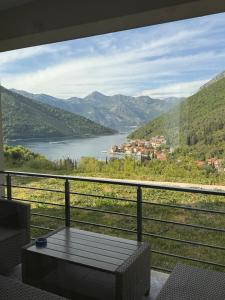 a balcony with a view of a river and mountains at Hil's Bay View - Terra in Lepetani