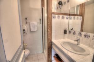 a bathroom with a sink and a toilet and a shower at Logis Hôtel Le Moulin de la Beune in Les Eyzies-de-Tayac