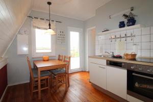 a kitchen with a table and a dining room at Finnhütte Achtern in Wustrow