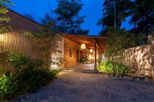 an exterior view of a house with a brick wall at Cascara Resort Weligama - A Tropical Sanctuary in Weligama
