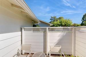 two chairs sitting on a fence next to a house at Silverado Resort and Spa 374 & 375 in Napa