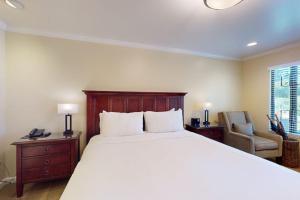 a bedroom with a large bed and a chair at Silverado Resort and Spa 374 & 375 in Napa