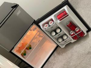 an open refrigerator with its door open andartmentsternessternessternessstrationstrationstrationterness at Relax Guest House in Oshawa