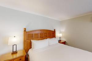 a bedroom with a bed with white sheets and two lamps at Silverado Resort and Spa 354 in Napa +31 photos