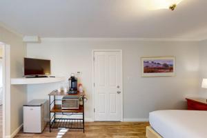 a bedroom with a bed and a television and a table at Silverado Resort and Spa 354 in Napa