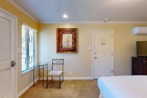 a bedroom with a bed and a chair and a television at Silverado Resort and Spa 375 in Napa