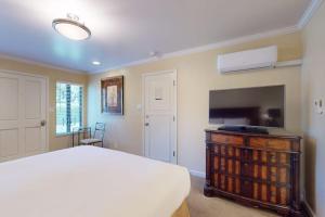 a bedroom with a bed and a flat screen tv at Silverado Resort and Spa 375 in Napa