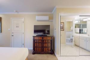 a living room with a television and a bathroom at Silverado Resort and Spa 375 in Napa