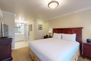 a bedroom with a large white bed and a television at Silverado Resort and Spa 375 in Napa +17 photos