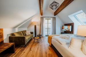 a bedroom with a bed and a couch at WALDGUT Naturresort in Bad Gottleuba
