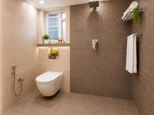 a bathroom with a toilet and a shower at Urban Comforts - Near US Consulate Business Hotel in T Nagar in Chennai +17 photos