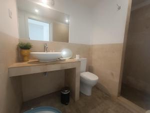 a bathroom with a sink and a toilet and a mirror at Tomarhousing - City Centre in Tomar