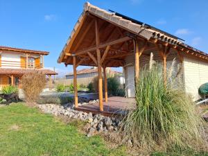 a wooden gazebo in the backyard of a house at ZanZebil in Zebil
