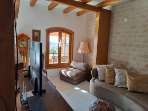 a living room with a couch and a tv at ZanZebil in Zebil